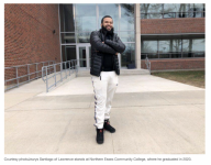 picture of jay santiago posing infront of building with folded arms and smiling