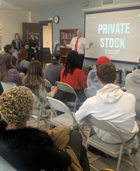 A picture showing Judge Jack Lu talking to students.