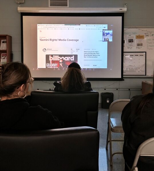 Students watching a presentation done by a NECC alum