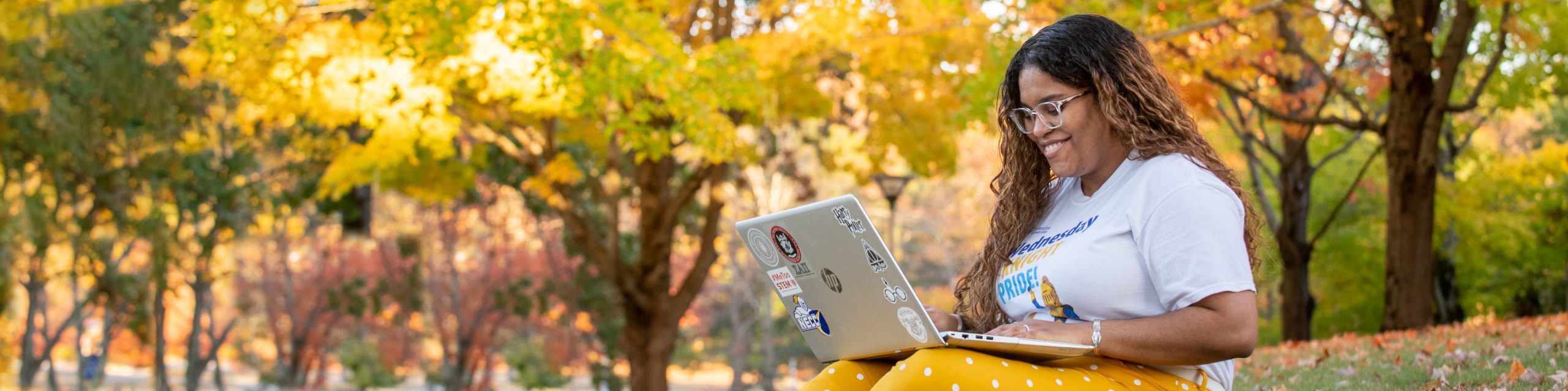Student on a laptop outside.