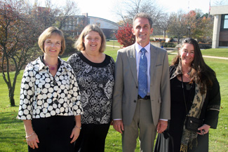 NECC employees Rebecca Rose, Trisha Foster, and Diana Mele photographed with NECC President Lane Glenn