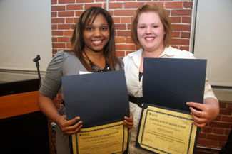 Anais Chiclana and Kristin Morrell proudly display their diplomas from the COMPASS Community College Collaborative