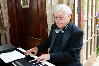 Phil Porter "the Pino Man" sitting at the piano keyboard.