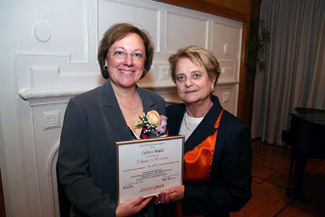 NECC employee Colleen Walsh accepts Tribute to Woman plaque from Rebecca Hall, executive director of the Lawrence YWCA