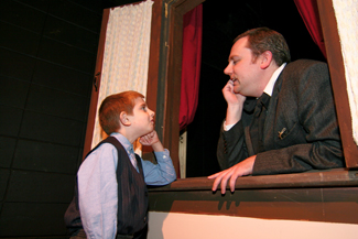 Max Howard of North Andover plays Boy In Street and Mark Morrison of Georgetown plays Scrooge in Northern Essex Community College’s adaptation of the Charles Dickens classic “A Christmas Carol” .