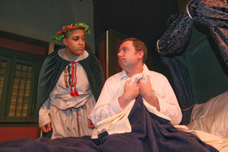 Adrian Peguero of Lawrence plays Christmas Present and Mark Morrison of Georgetown plays Scrooge in Northern Essex Community College’s adaptation of the Charles dickens classic, “A Christmas Carol” 