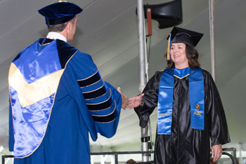 Alice Beauchamp of Newburyport receives diploma from NECC President Lane Glenn.