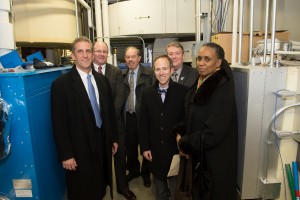 Left to right: Lane Glenn, president, NECC; Bruce Edwards, manager of commercial sales, National Grid, Massachusetts North; Peter Dulchinos, NECC board of trustees; Mark Sylvia, commissioner, Department of Energy Resources; Bill Moynihan, chair, NECC board of trustees, and Carole Cornelison, commissioner, Division of Capital Asset Management and Maintenance.  They're standing in front of one of the new energy efficient boilers that was installed as part of the project.