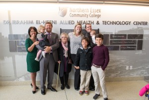 The El-Hefni family standing in front of the wall honoring Dr. Ibrahim El-Hefni.