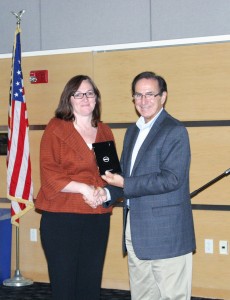 Kymberly Codair, who waschosen as the college's top entrepreneurial student, receiving her Dell tablet from Bill Zannini