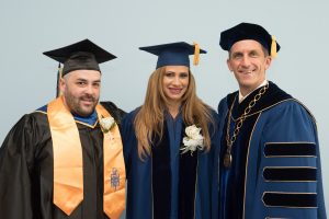 NECC student speaker Ray Florent, guest commencement speaker Attorney Wendy Estrella, and NECC President Lane Glenn.