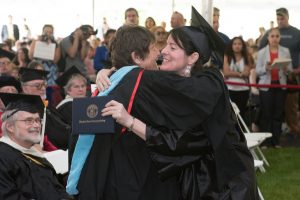 Emeritus recipient Linda Desjardins, English faculty member, hugs Kim Whiting, who received her Associate in Arts: Journalism/Communication Option.