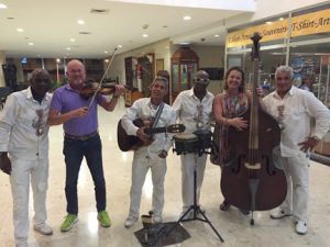 Professor Ligia Domenech hams it up with street musicians in Cuba.