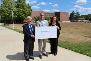 Attorney Jay Cleary, President of the Board of Trustees at HC Media and Darlene Beal, executive director of HC Media, present NECC President Lane Glenn with a check for journalism/communication scholarships. 