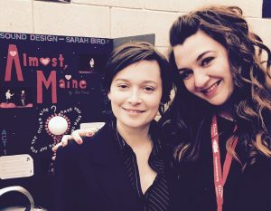 NECC theater major Sarah Bird and adjunct theater professor Brianne Beatrice stand in front of Bird's presentation for the Kennedy Center American College Theater Festival sound design exhibition, for which she won the Focal Press/Rafael Jaen Showcase Award for Excellence in Sound Design.