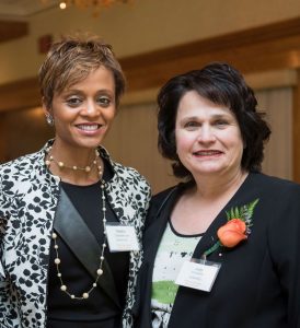 Noemi Custodia-Lora and Judy Chmielecki smile side by side for the camera