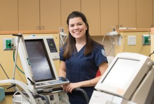 Webb Standing among respiratory equipment