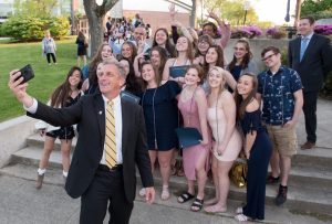 NECC President Lane Glenn takes a selfie with HHS seniors.