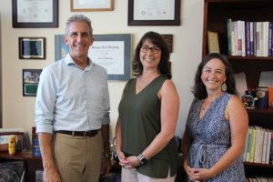 NECC President Lane Glenn congratulates employees Kathleen Bartolini and Janet D'Agata-Lynch on receiving Employee Recognition Award