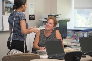 advisor Linda Comeau with an NECC student talking.n