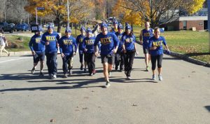 President Lane Glenn with faculty, staff, and students running on the Haverhill campus.