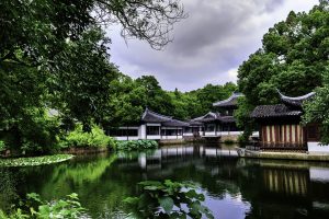 A photo of the natural landscape of China with homes located on the water