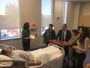 Massachusetts legislators tour the simulation lab and view how a simulation mannequin works. 