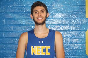 Kyle Manley smiles wearing his cross country jersey