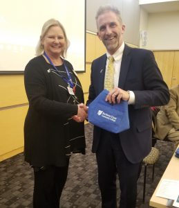 President Glenn shakes hands with new employee Nancy Sleger.