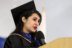 Yexis Hechavarria in cap and gown delivering the 2019 student commencement speech. 