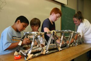 Four young children constructing a craft during College for Kids 