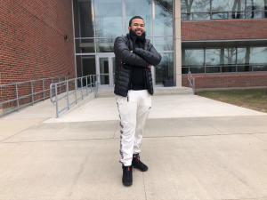 Jeurys standing in front of brick NECC building