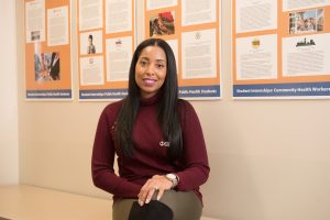 Portrait of Roseanna Lara sitting in an NECC hallway.