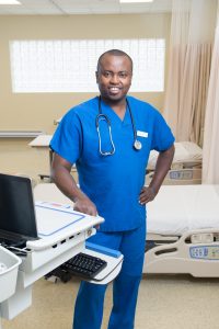 Male nursing student poses in NECC's Nursing Lab.