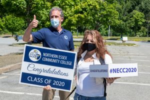 President Lane Glenn gives the thumb up with NECC 2020 grad. Both are wearing masks.