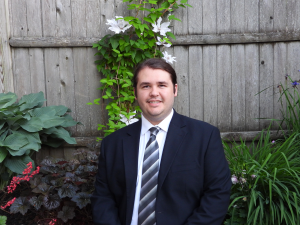 photo of lab science major Tyler Sheltry in a yard surrounded by a fence.