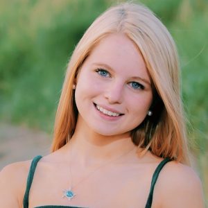 portrait of smiling young woman with long blond hair