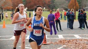 Two young woman participate in cross country running meet.