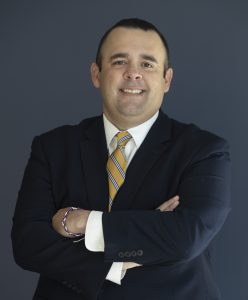 Man in blue suit with yellow tie