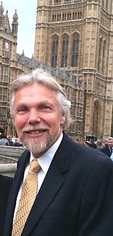 Dr Stephen Valle standing smiling outside of parliament in London