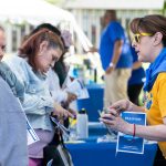 interested students talk with advisor wearing yellow and blue NECC gear