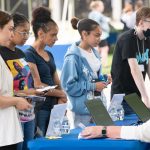 interested students speak to advisors at a table