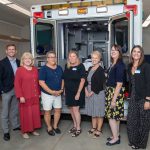 group shot in front of ambulance used for paramedic training