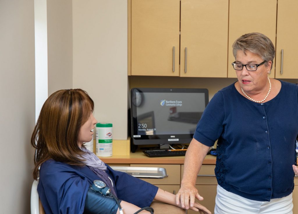 kathy hudson points to a sophisticated manequinn used for simulating health care scenarios