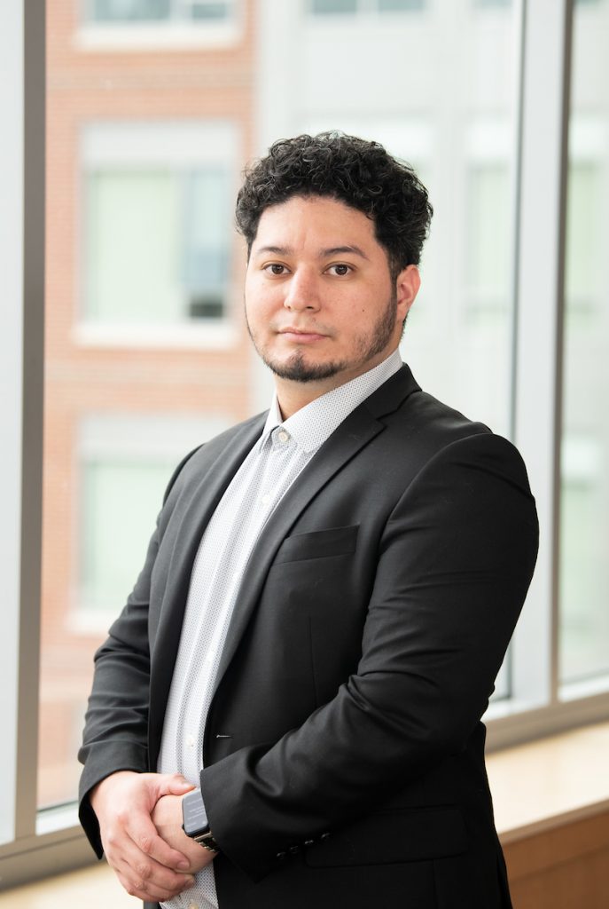 jonathan poses with dark blazer and white shirt