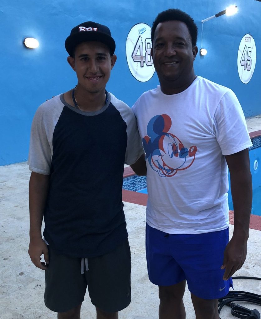 jose poses with his arm around pedro, both smiling at camera