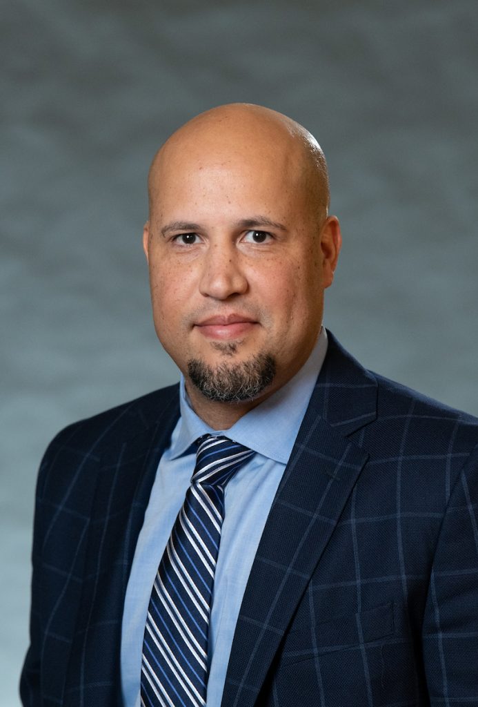 headshot of evan wearing suit and tie 