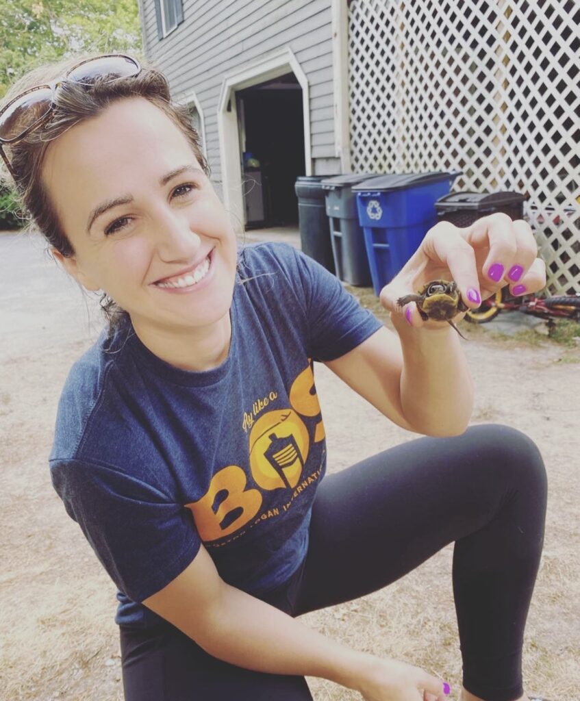 heather holds up baby turtle 