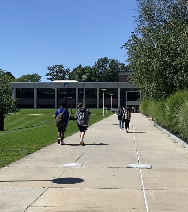 students seen walking toward the student center building