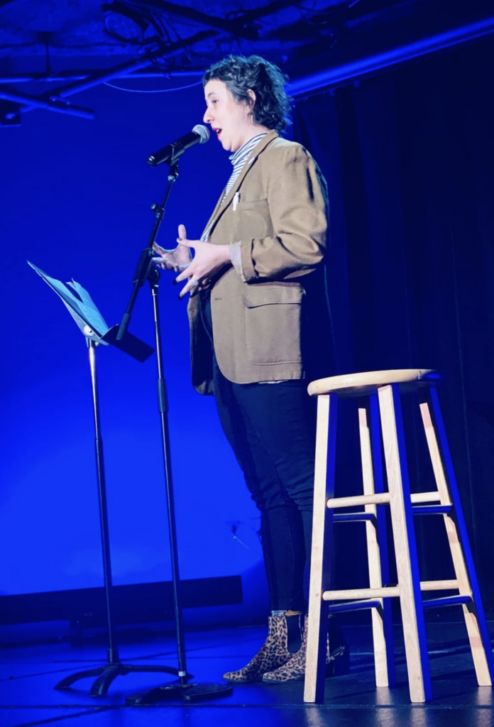 caitlin little on stage at the Art Space show